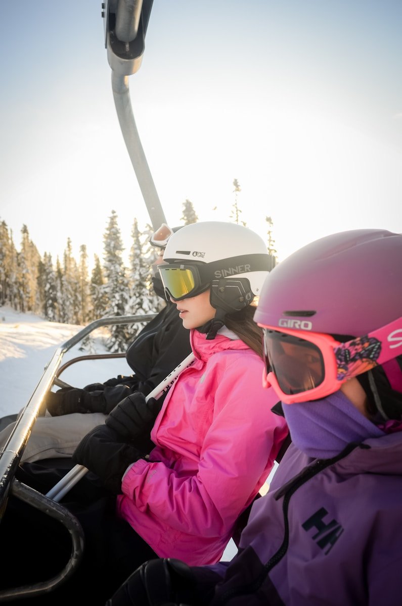 A couple of people riding a ski lift